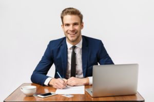 Business, office and corporate concept. Handsome, cheerful blond bearded guy in classic suit