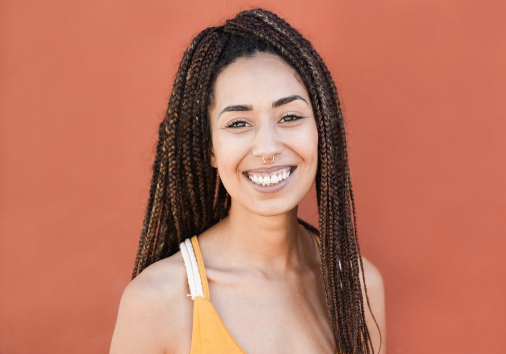 Happy hippie mixed race girl smiling in camera